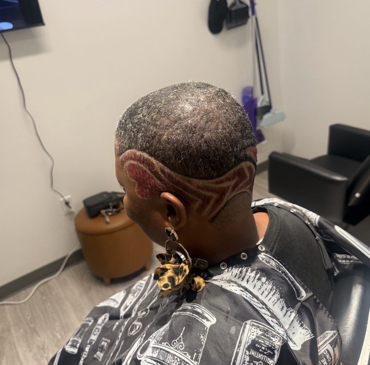 Freestyle hair design with red color detail at Bud Kutz